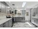 Well-lit kitchen featuring gray cabinets, quartz countertops, stainless steel appliances, stylish back splash and wood floors at 509 Altaloma Ave, Orlando, FL 32803