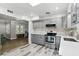 Kitchen offering stainless steel appliances, quartz countertops, gray cabinets, and view to dining and living areas at 509 Altaloma Ave, Orlando, FL 32803