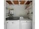 Functional laundry room with white washer and dryer and compact water heater at 509 Altaloma Ave, Orlando, FL 32803
