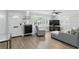 Open living room layout with hardwood floors, a gray sectional, and ample natural light from the large window with shutters at 509 Altaloma Ave, Orlando, FL 32803