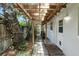 Cozy covered walkway with brick pavers leads to the entrance of the charming home, surrounded by lush greenery at 509 Altaloma Ave, Orlando, FL 32803