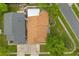 Aerial view of a property with a brown roof, green trees and a neatly paved driveway at 5324 Barefoot Path, Kissimmee, FL 34746