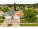 Aerial view of a single-Gathering home with a well-maintained yard and mature trees at 5324 Barefoot Path, Kissimmee, FL 34746