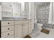 Bathroom featuring tile floors, vanity with storage and shower/tub combo with patterned curtain at 5324 Barefoot Path, Kissimmee, FL 34746