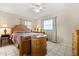 Comfortable bedroom with a ceiling fan, tile floors, and natural light at 5324 Barefoot Path, Kissimmee, FL 34746