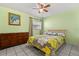 Bedroom with a ceiling fan, tile floors, and a bed with floral bedding and wooden frame at 5324 Barefoot Path, Kissimmee, FL 34746