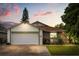 Charming single-Gathering home with attached garage and lush front yard landscaping at 5324 Barefoot Path, Kissimmee, FL 34746