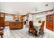 Open kitchen and dining area with tile flooring, wooden cabinets, and a ceiling fan at 5324 Barefoot Path, Kissimmee, FL 34746