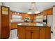 Spacious kitchen with a central island, wooden cabinets, and modern appliances at 5324 Barefoot Path, Kissimmee, FL 34746