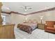 Main bedroom featuring tile floors, ceiling fan and a classic styled bed and matching furniture at 5324 Barefoot Path, Kissimmee, FL 34746