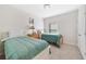 Comfortable bedroom with two beds, carpet flooring, and a window for natural light at 540 Vitoria Rd, Davenport, FL 33837