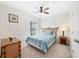 Stylish bedroom featuring a unique headboard, ceiling fan, and natural light at 540 Vitoria Rd, Davenport, FL 33837