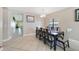 Open dining area with tile floors, a chandelier, and a large window for natural light at 540 Vitoria Rd, Davenport, FL 33837