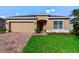 Charming single-story home featuring a well-manicured lawn, brick driveway and a two-car garage at 540 Vitoria Rd, Davenport, FL 33837