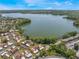Expansive aerial view of a lakeside community offering beautiful waterfront living and serene natural surroundings at 604 Desoto Dr, Casselberry, FL 32707