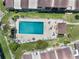 Aerial view showcasing a community pool, sun deck, and lounge seating at 604 Desoto Dr, Casselberry, FL 32707