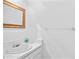 Clean, well-lit half-bathroom features a minimalist design with a white vanity, mirror, and neutral wall color at 604 Desoto Dr, Casselberry, FL 32707