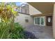 Charming courtyard featuring vibrant greenery, a decorative stone floor, and a glass window adding architectural interest at 604 Desoto Dr, Casselberry, FL 32707