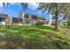 Lakeside exterior view of community townhomes with screened patios and lush green lawns at 604 Desoto Dr, Casselberry, FL 32707