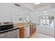 Well-lit kitchen featuring stainless steel appliances, wood cabinets, and easy access to the adjacent living area at 604 Desoto Dr, Casselberry, FL 32707