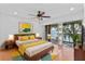 Comfortable main bedroom featuring a private balcony with lake views and modern decor at 604 Desoto Dr, Casselberry, FL 32707