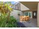 Private patio with outdoor seating, lush greenery and unique architectural details at 604 Desoto Dr, Casselberry, FL 32707