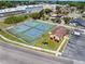 Aerial view of pristine tennis courts in a well maintained community with lush landscaping at 604 Desoto Dr, Casselberry, FL 32707