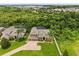 Beautiful aerial view of a home with a well-manicured lawn, mature trees, and a screened-in lanai in a serene setting at 748 Duff Dr, Winter Garden, FL 34787