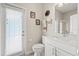 Bathroom featuring a white vanity, shower, toilet, and door to the exterior patio at 748 Duff Dr, Winter Garden, FL 34787