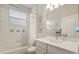 Bright bathroom with tiled backsplash, shower and tub combination, and white vanity at 748 Duff Dr, Winter Garden, FL 34787