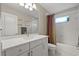 Clean bathroom with a white vanity, large mirror, and a shower-tub combination at 748 Duff Dr, Winter Garden, FL 34787