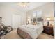 Bedroom featuring a ceiling fan, window with plantation shutters, and a closet at 748 Duff Dr, Winter Garden, FL 34787