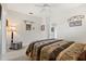 Bedroom featuring ceiling fan, neutral walls and carpet, and ensuite bathroom entrance at 748 Duff Dr, Winter Garden, FL 34787