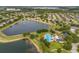 Aerial view showing a serene lake, community pool, playground, and walking trails in a desirable neighborhood setting at 748 Duff Dr, Winter Garden, FL 34787