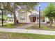 Charming community clubhouse featuring a welcoming red door, a cozy porch, and well-maintained landscaping at 748 Duff Dr, Winter Garden, FL 34787