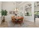 Formal dining room with a wooden table, chairs, and a decorative light fixture at 748 Duff Dr, Winter Garden, FL 34787