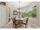 Bright dining room boasts a glass table, wood chairs, and views of the lush landscaping at 748 Duff Dr, Winter Garden, FL 34787