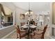 Light and bright dining room features a glass table, wood chairs, and views of the outdoor lanai at 748 Duff Dr, Winter Garden, FL 34787