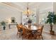 Bright dining area featuring a round wooden table with six chairs and decorative lighting at 748 Duff Dr, Winter Garden, FL 34787