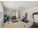 Bright exercise room with neutral carpet, ceiling fan, and an array of workout equipment at 748 Duff Dr, Winter Garden, FL 34787