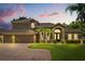 Charming home with three-car garage, well-kept lawn, and front yard with small palm trees at 748 Duff Dr, Winter Garden, FL 34787