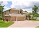 Beautiful two-story home with an attached three-car garage and neatly manicured landscaping at 748 Duff Dr, Winter Garden, FL 34787