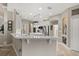 This bright kitchen features white cabinets, stainless steel appliances, recessed lighting, and a large center island at 748 Duff Dr, Winter Garden, FL 34787