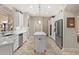 Bright kitchen with stainless appliances, white cabinets, recessed lighting, and island offers ample counter space at 748 Duff Dr, Winter Garden, FL 34787