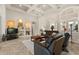Living area with tile floors, decorative nooks, a dark leather sofa, and modern lighting at 748 Duff Dr, Winter Garden, FL 34787