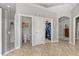 Bright main bathroom featuring tiled floor, glass shower, walk-in closet, and separate water closet at 748 Duff Dr, Winter Garden, FL 34787