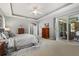 Spacious main bedroom features neutral tones, a tray ceiling, ceiling fan, and sliding glass doors to the lanai at 748 Duff Dr, Winter Garden, FL 34787