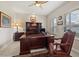 Comfortable home office with a wooden desk, chair, and a ceiling fan at 748 Duff Dr, Winter Garden, FL 34787