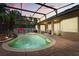Sunset view of outdoor pool and patio with mature landscaping and screened enclosure at 748 Duff Dr, Winter Garden, FL 34787
