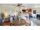 Charming dining area with adjacent kitchen, wood floors, and neutral accents at 7810 Grevillea Dr, Orlando, FL 32822